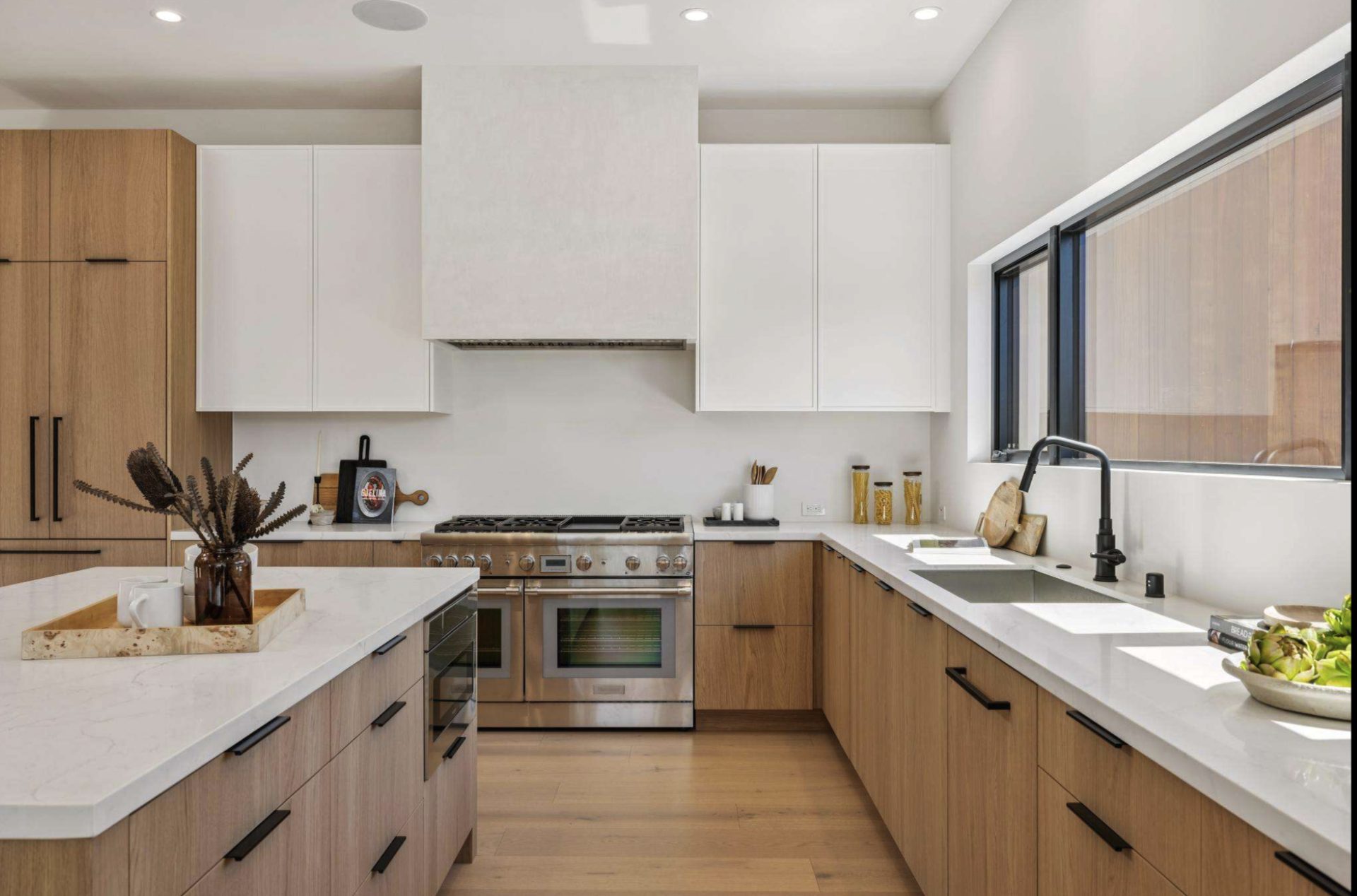 Custom kitchen with Shinnoki ivory oak cabinets, painted skinny shaker uppers, and fluted island panel — DodiHome Tiburon project