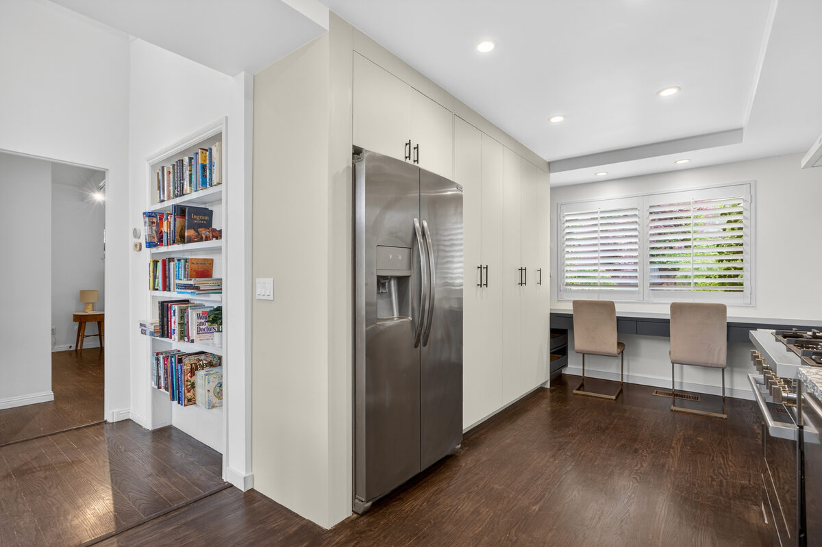 Painted flat panel kitchen with floor-to-ceiling fridge panel and built-in desk — DodiHome Mill Valley