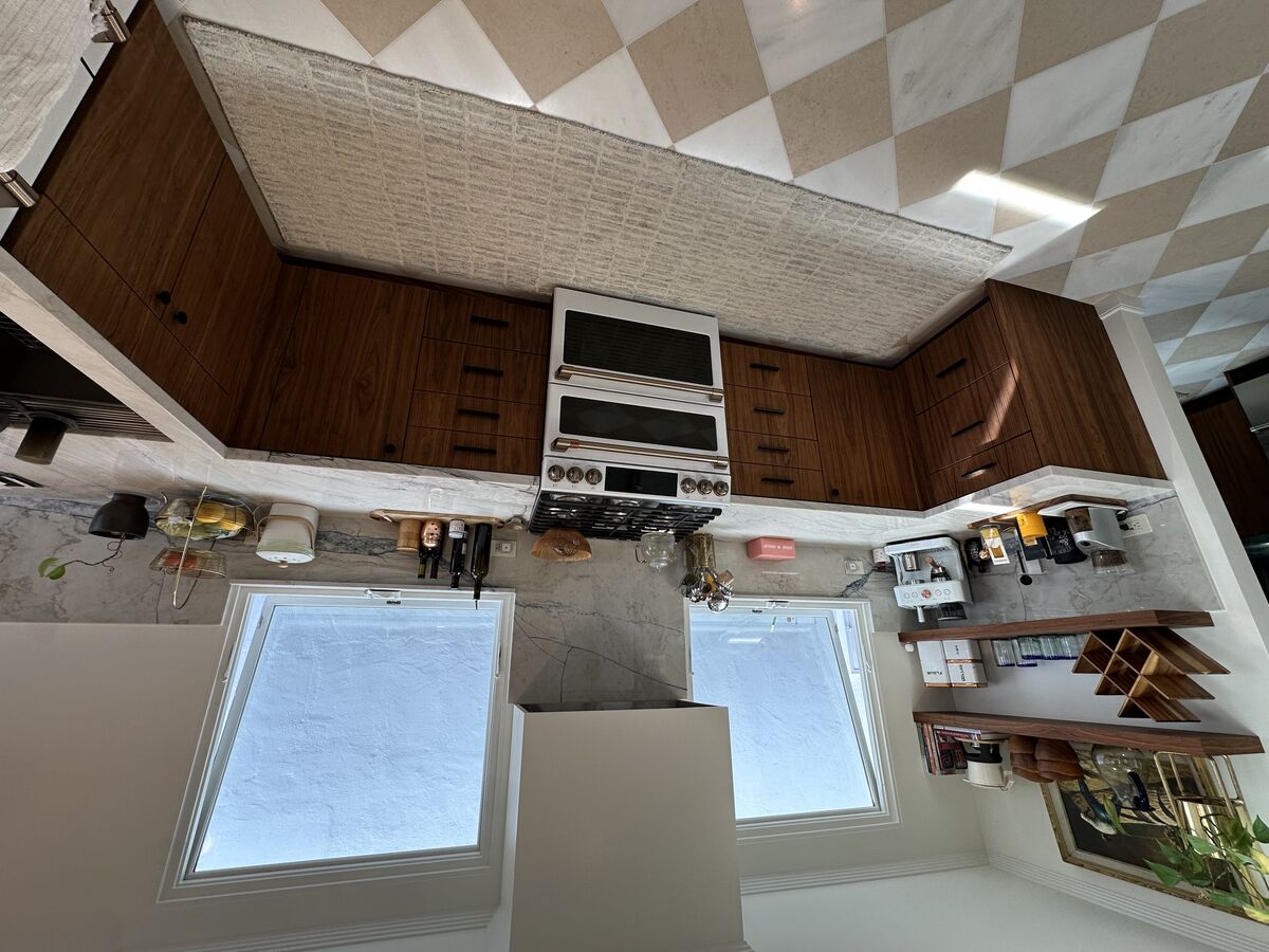 Walnut flat panel kitchen cabinets with marble countertops in a Bay Area kitchen remodel