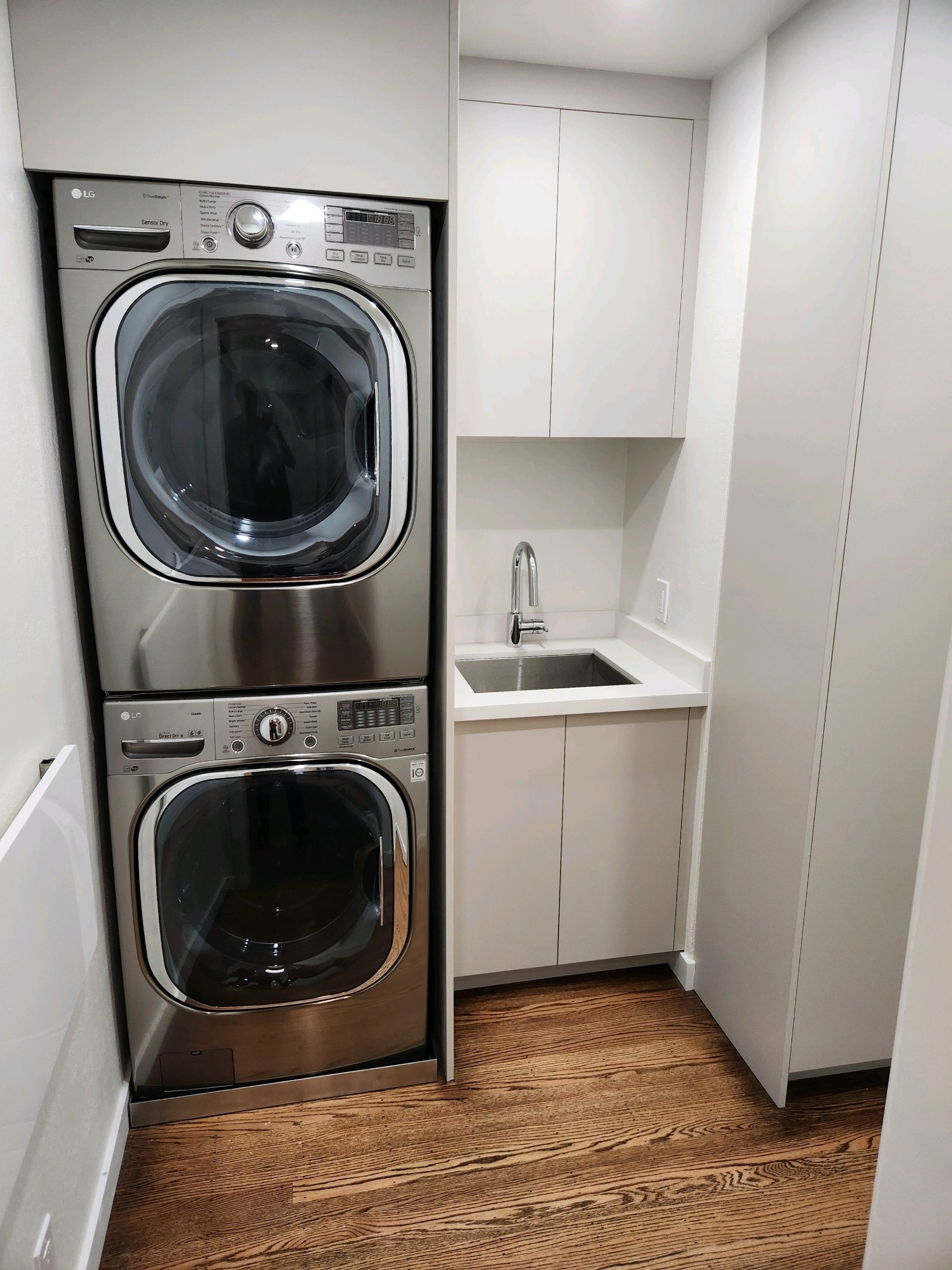 Primary finished-room view of compact laundry cabinetry cabinetry and surrounding surfaces