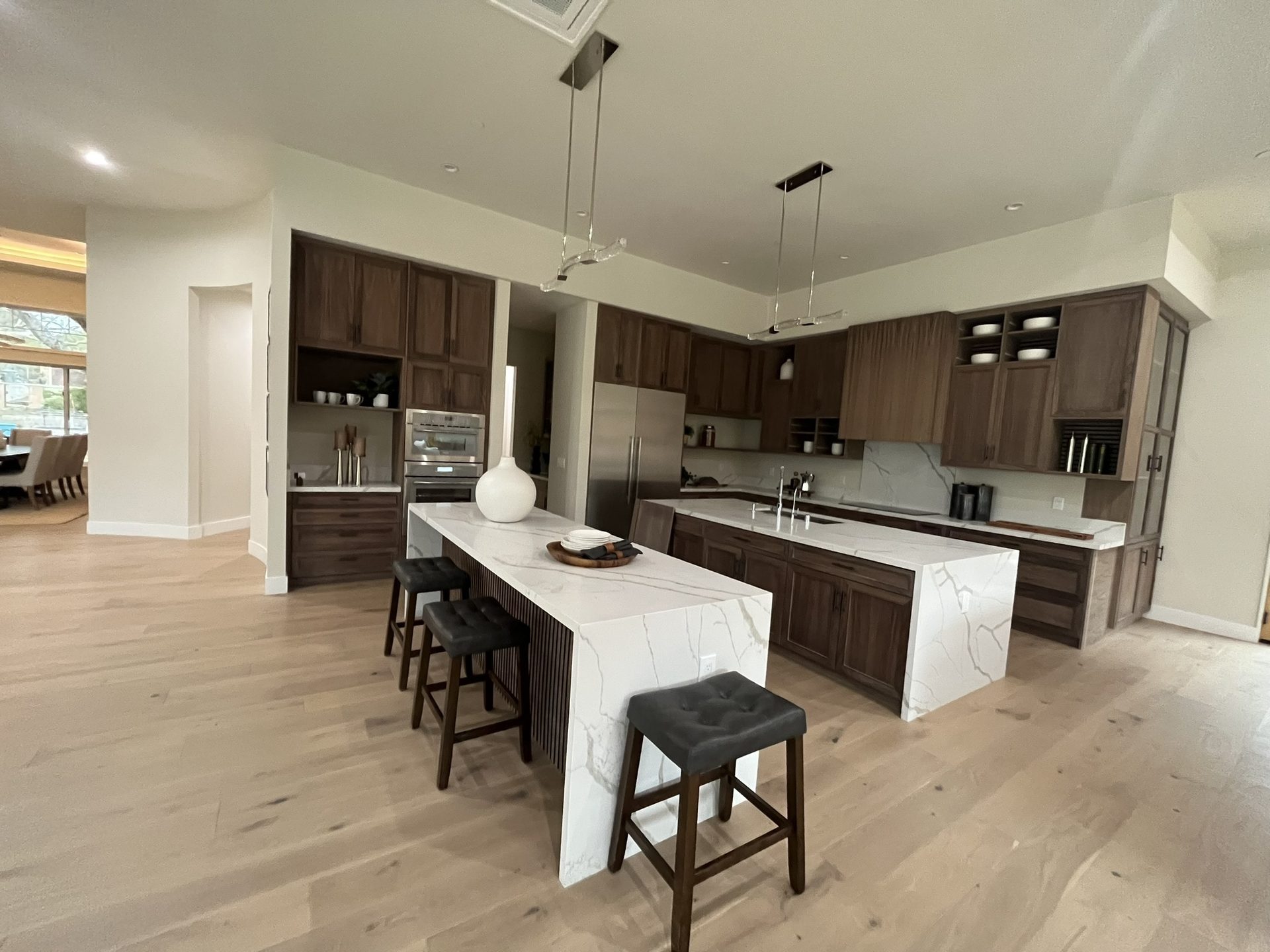 Primary finished-room view of dark wood open-plan kitchen cabinetry and surrounding surfaces