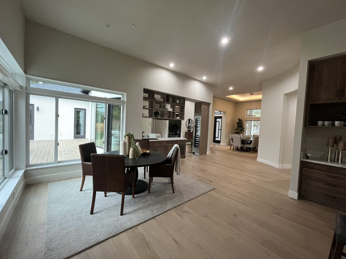 Second finished-room view of dark wood open-plan kitchen cabinetry and surrounding surfaces