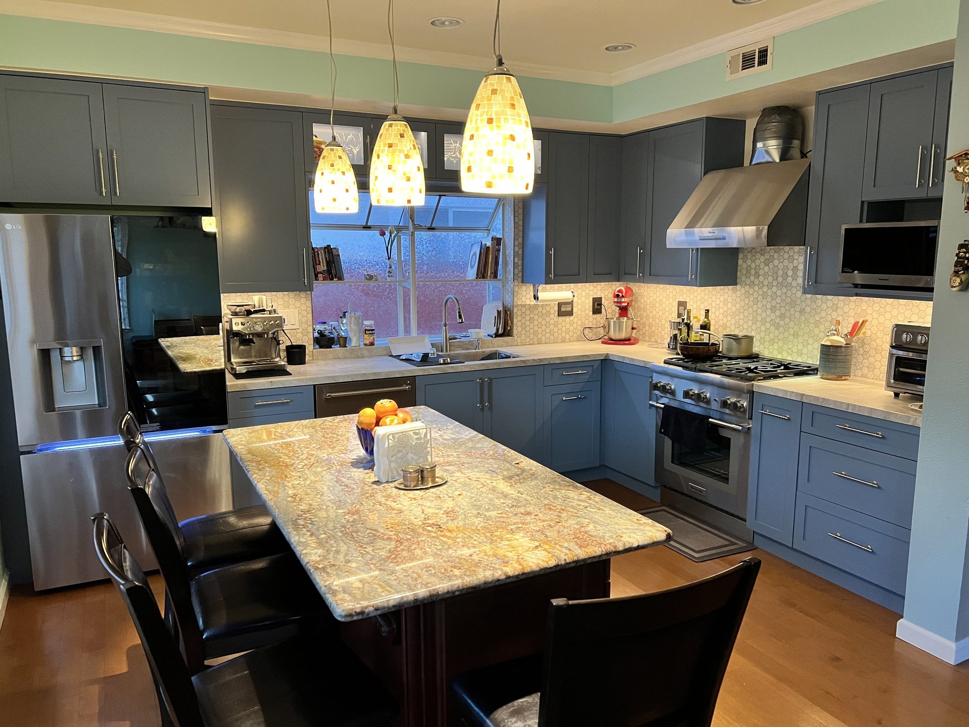 Primary finished-room view of blue shaker kitchen in the east bay cabinetry and surrounding surfaces