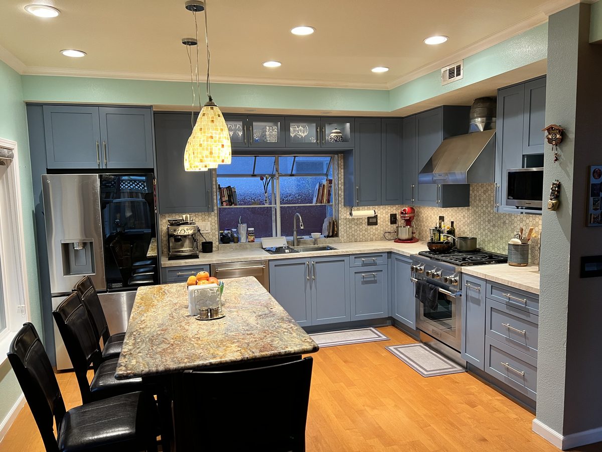 Second finished-room view of blue shaker kitchen in the east bay cabinetry and surrounding surfaces