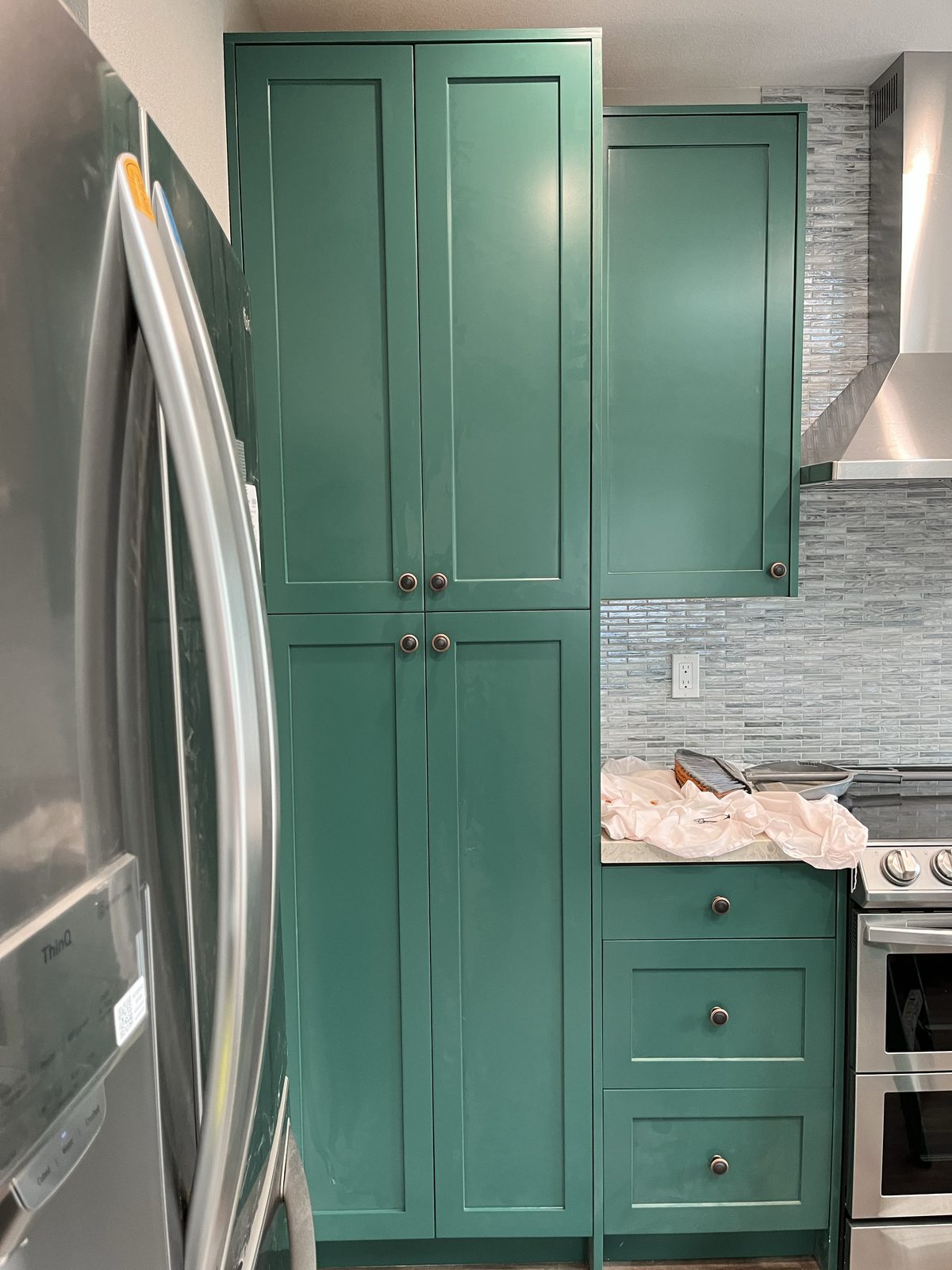 Primary finished-room view of green full-height cabinetry cabinetry and surrounding surfaces