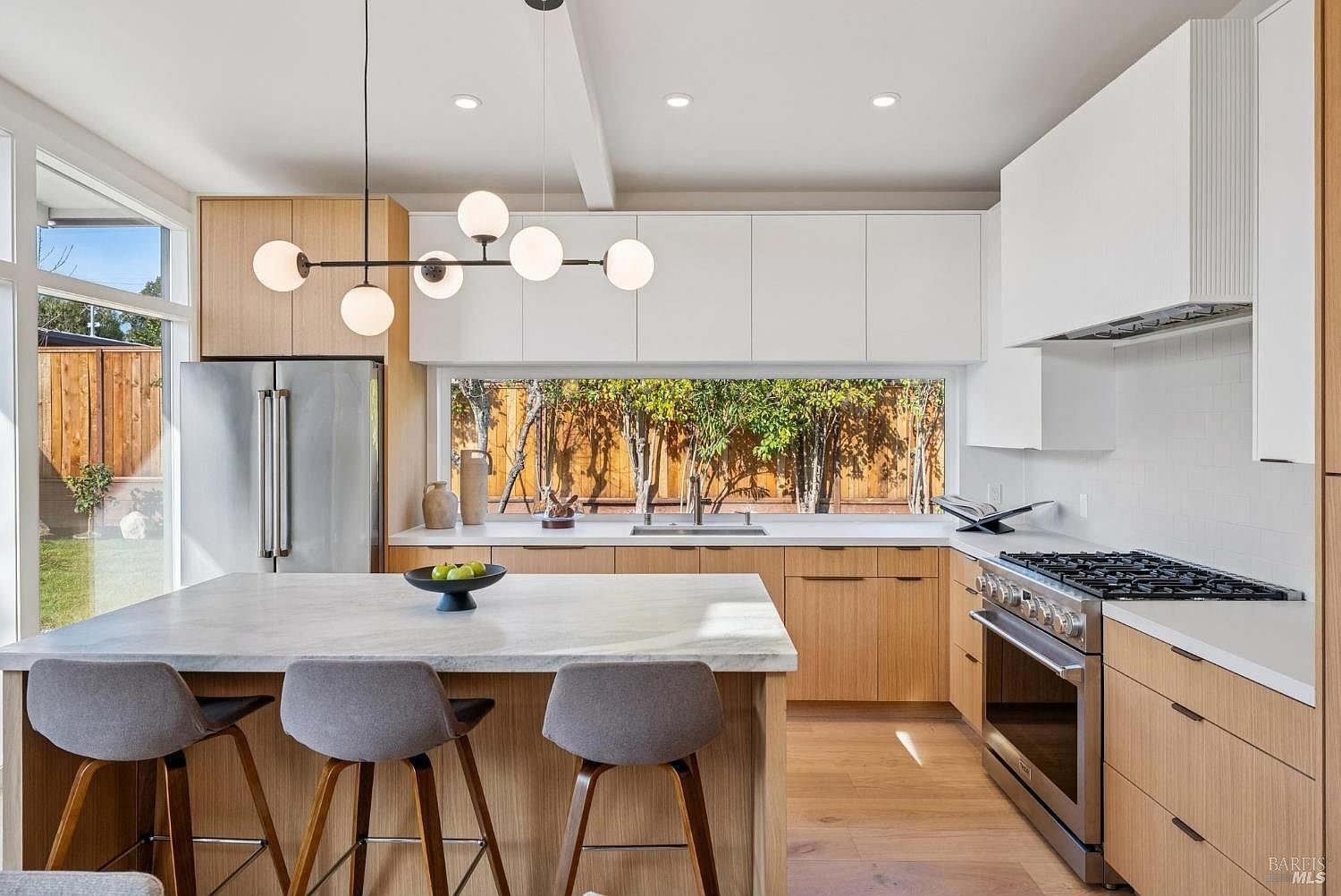 Primary finished-room view of indoor-outdoor natural wood kitchen cabinetry and surrounding surfaces