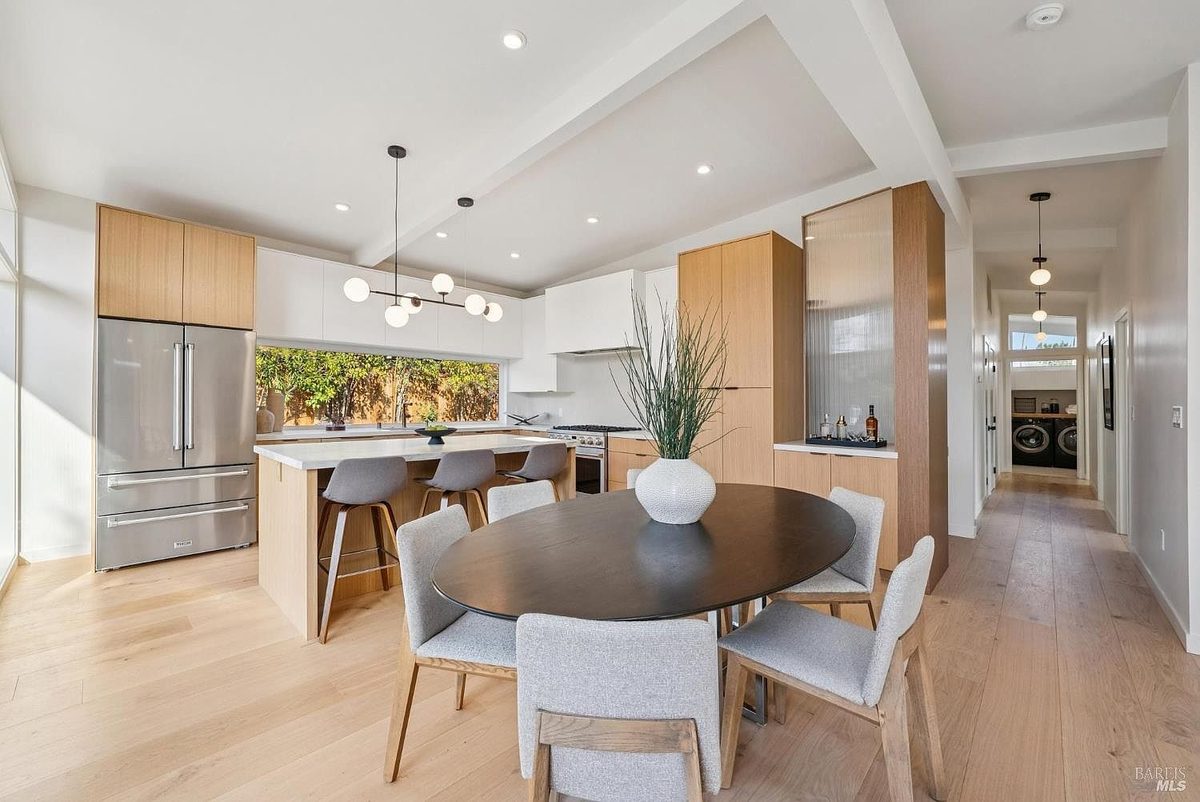 Second finished-room view of indoor-outdoor natural wood kitchen cabinetry and surrounding surfaces
