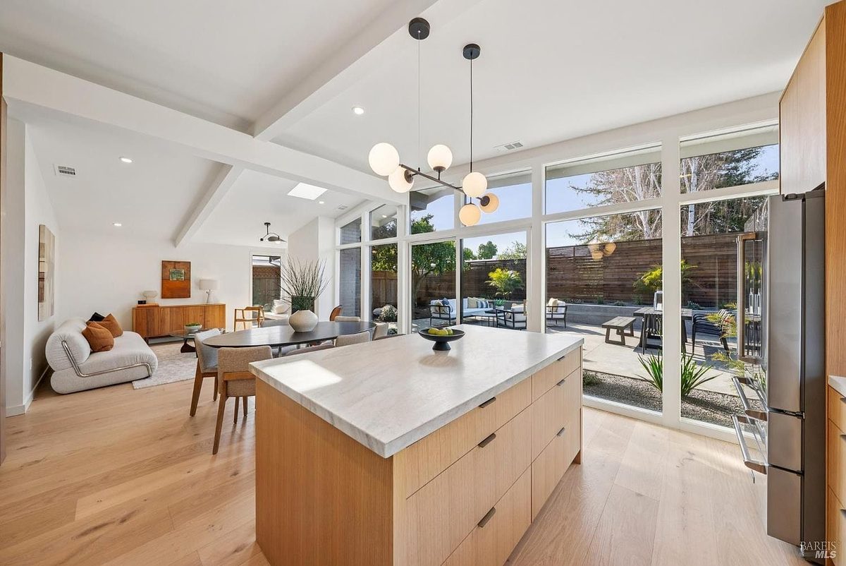 Sixth finished-room view of indoor-outdoor natural wood kitchen cabinetry and surrounding surfaces