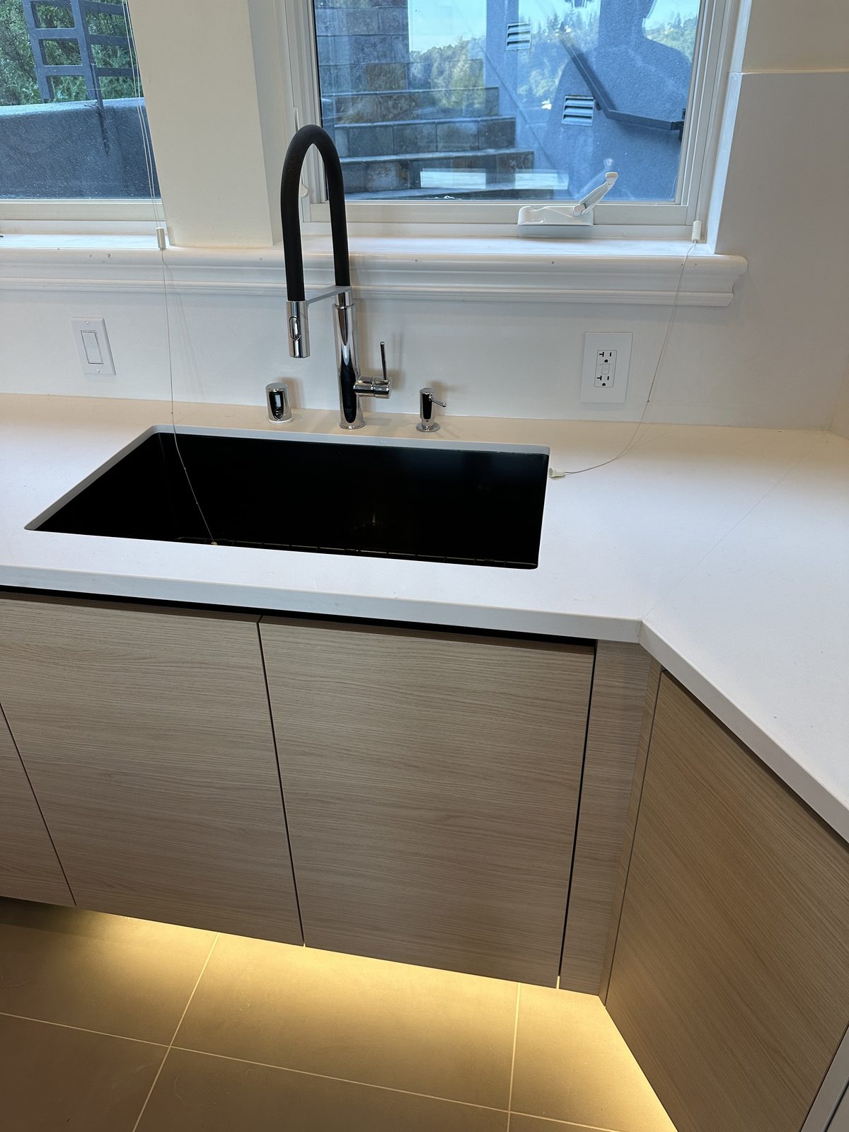 Fourth finished-room view of light oak kitchen with integrated lighting cabinetry and surrounding surfaces