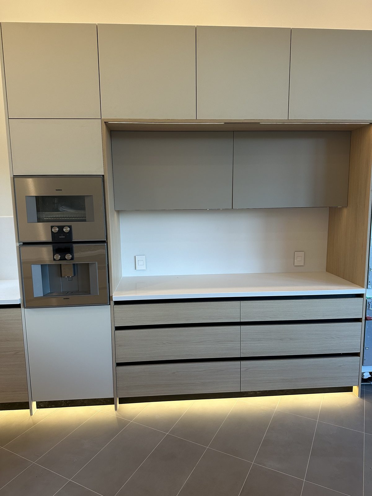 Sixth finished-room view of light oak kitchen with integrated lighting cabinetry and surrounding surfaces