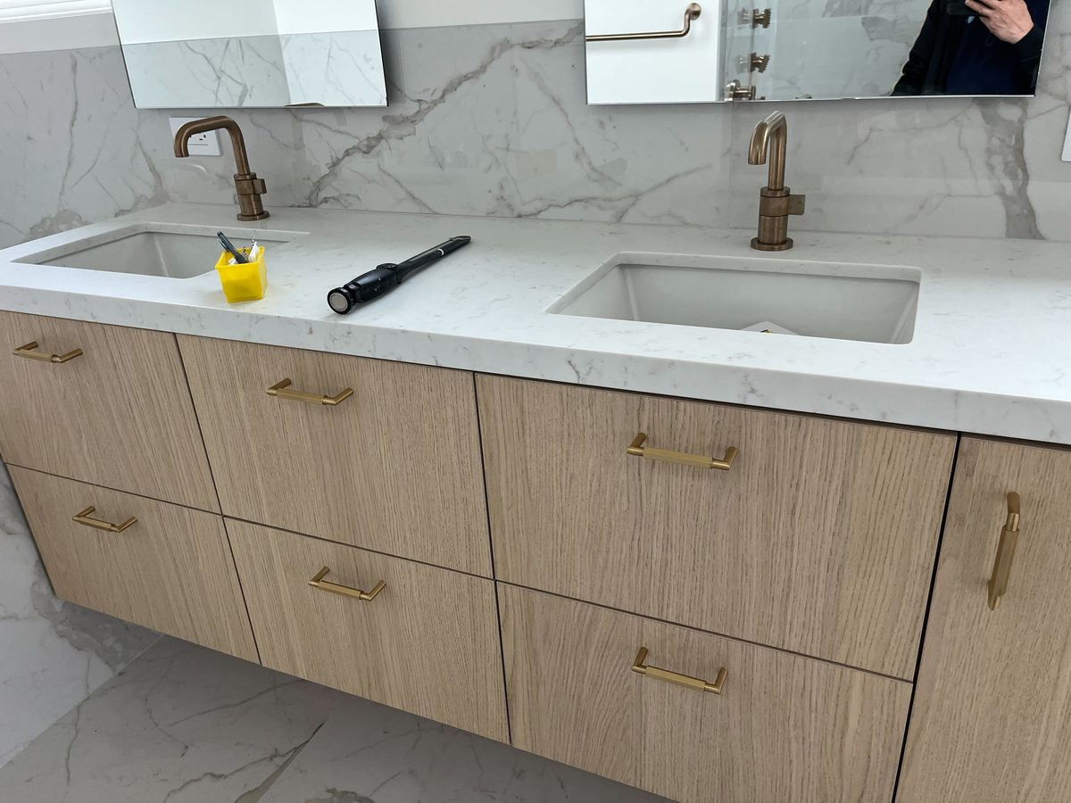 Primary finished-room view of milk oak vanity cabinetry and surrounding surfaces