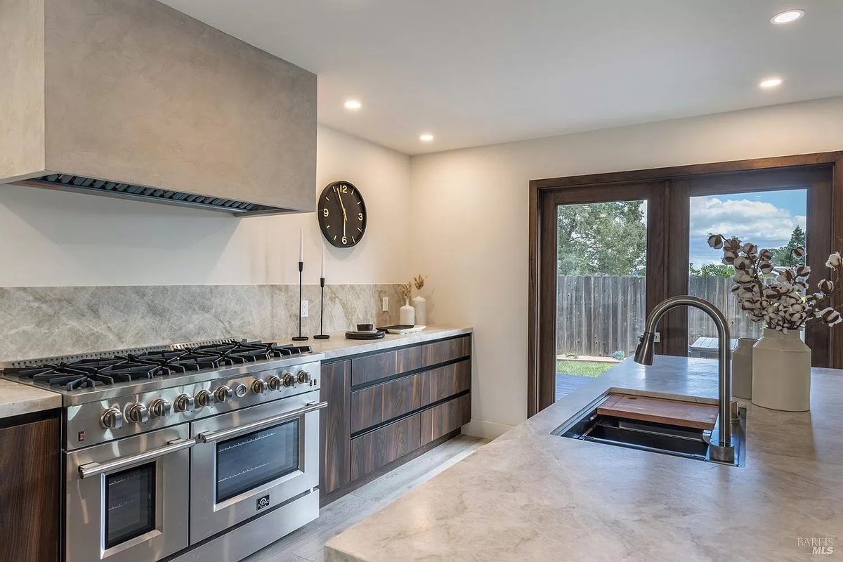 Second finished-room view of walnut kitchen & vanity in napa cabinetry and surrounding surfaces