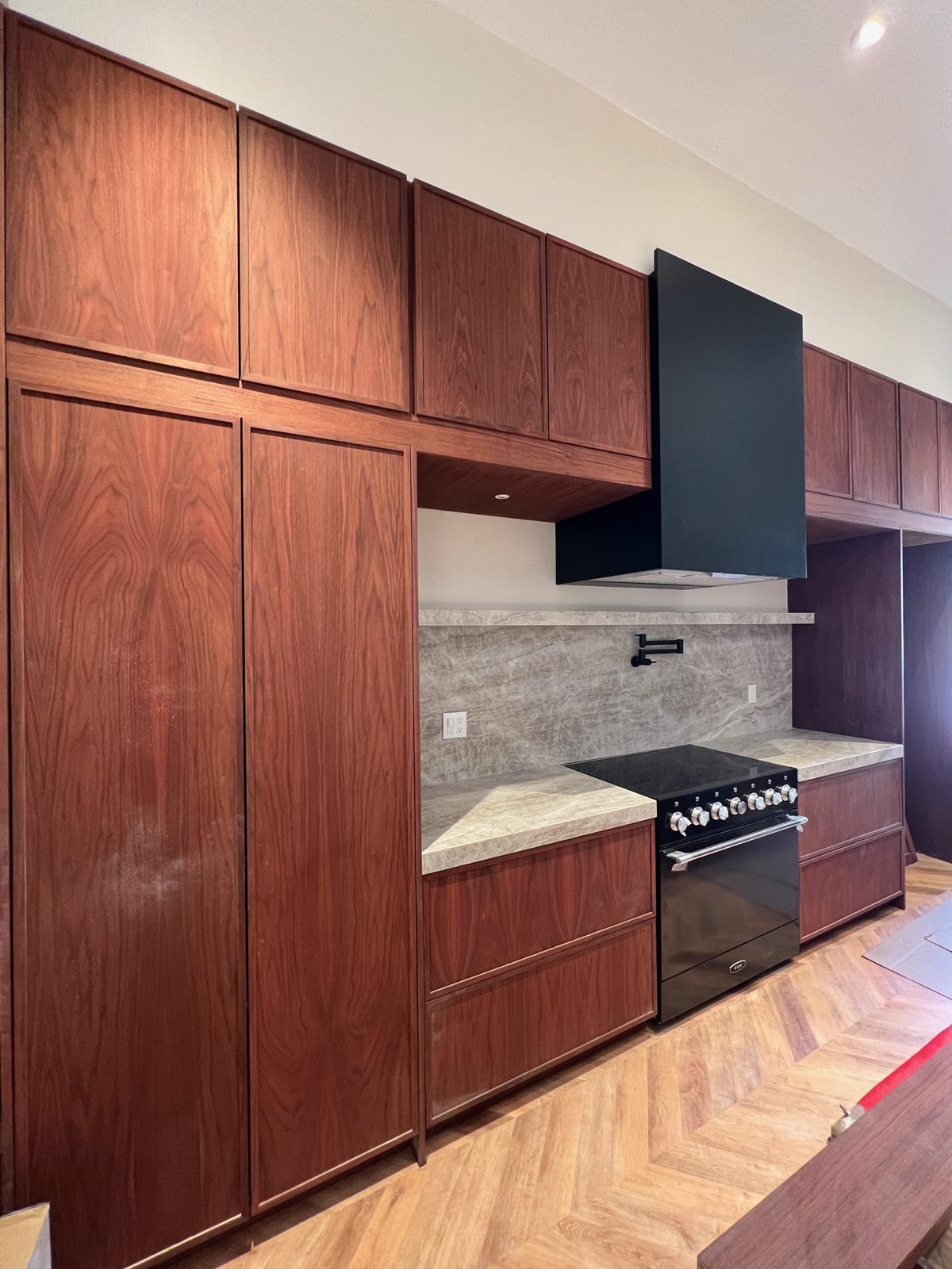 Second finished-room view of warm oak kitchen in oakland cabinetry and surrounding surfaces
