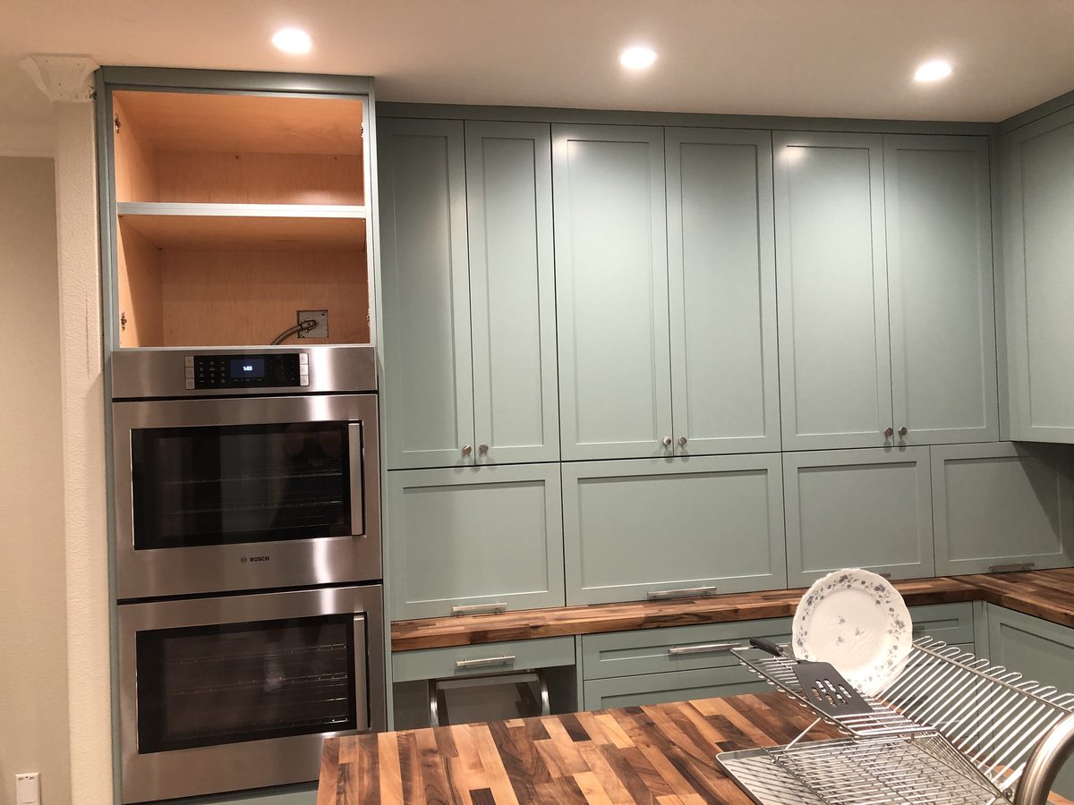 Primary finished-room view of sage green kitchen cabinetry and surrounding surfaces