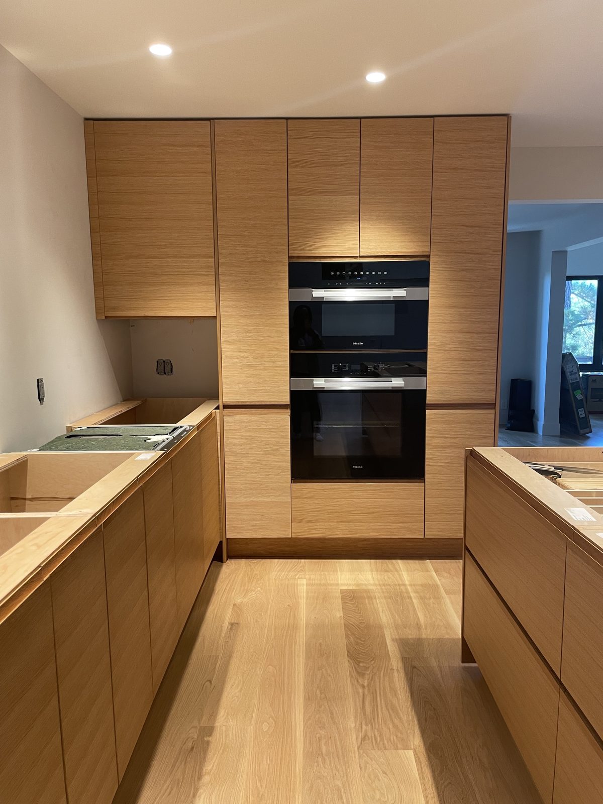 Second finished-room view of light oak kitchen in san carlos cabinetry and surrounding surfaces