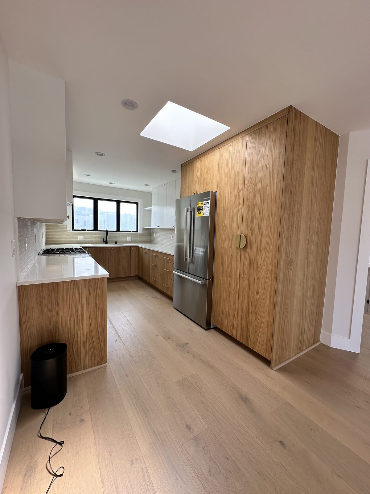 Second finished-room view of light wood kitchen & bath in san francisco cabinetry and surrounding surfaces