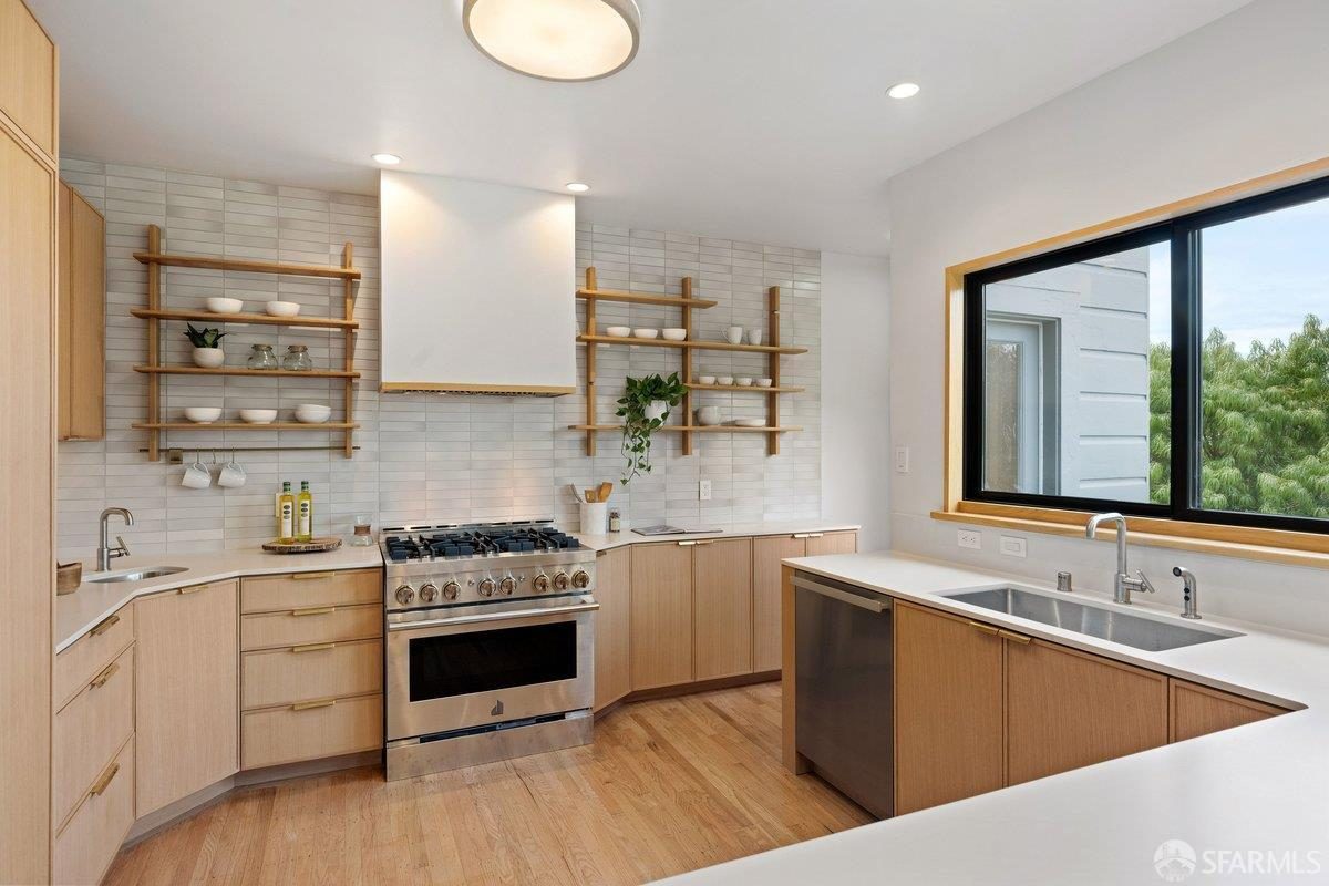 Second finished-room view of warm wood island kitchen cabinetry and surrounding surfaces in San Francisco