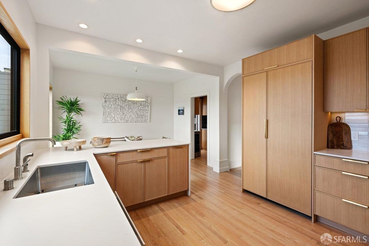 Fifth finished-room view of warm wood island kitchen cabinetry and surrounding surfaces in San Francisco