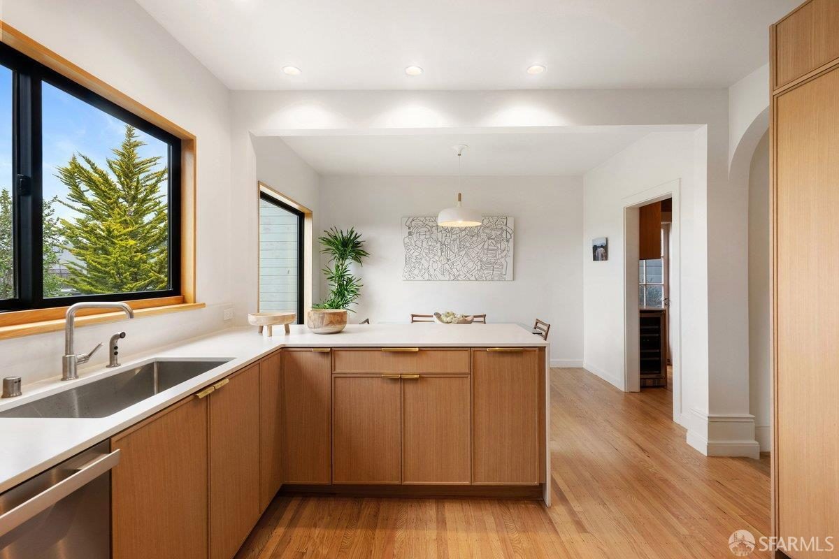 Sixth finished-room view of warm wood island kitchen cabinetry and surrounding surfaces in San Francisco