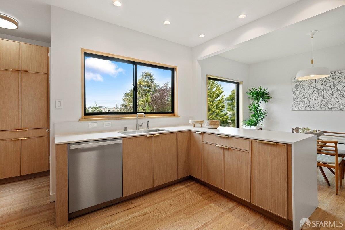 Seventh finished-room view of warm wood island kitchen cabinetry and surrounding surfaces in San Francisco