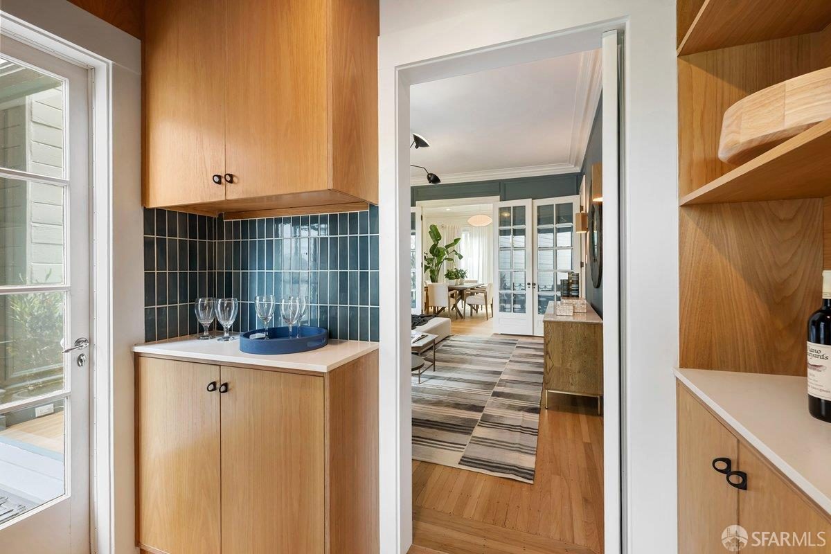 Eighth finished-room view of warm wood island kitchen cabinetry and surrounding surfaces in San Francisco