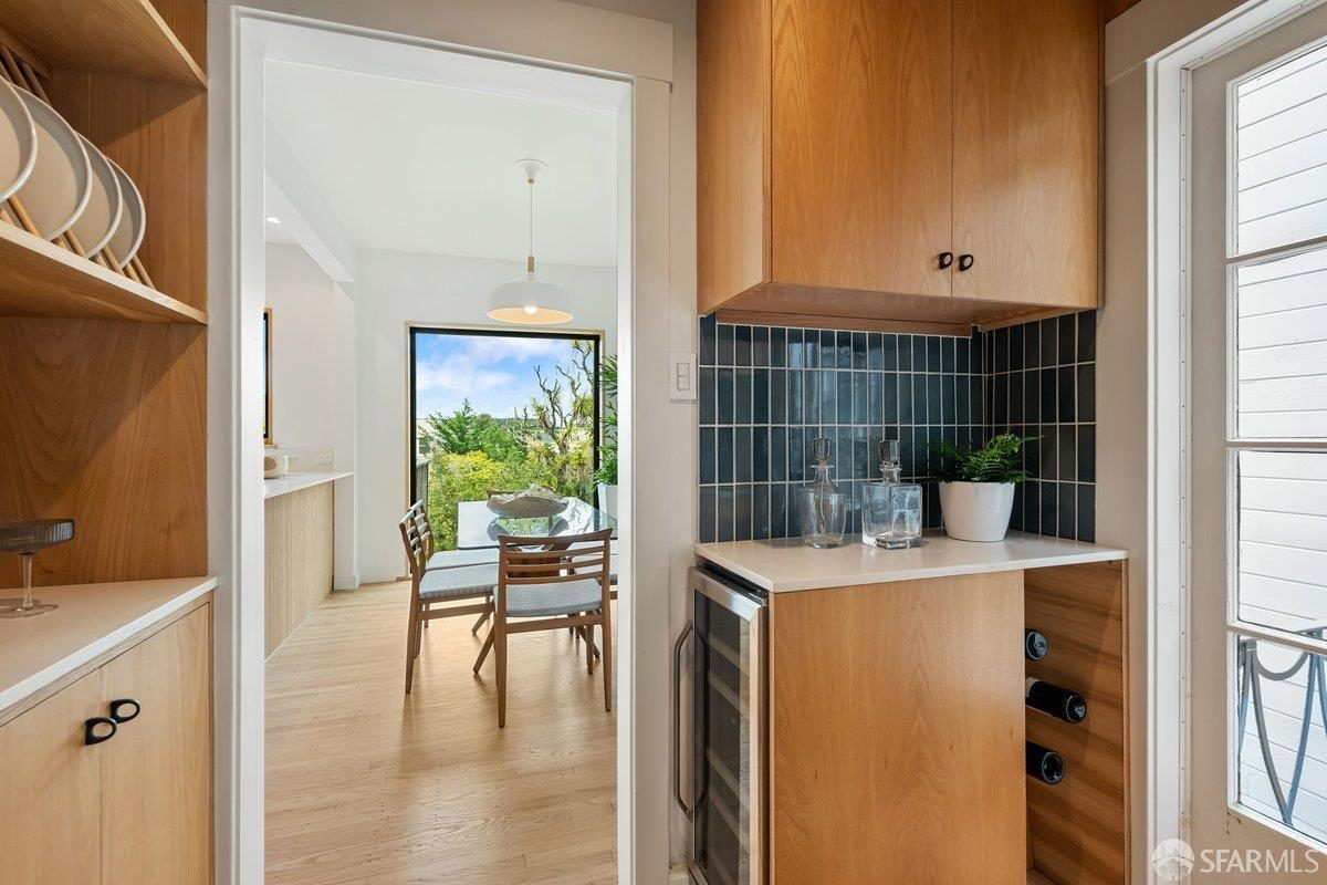 Ninth finished-room view of warm wood island kitchen cabinetry and surrounding surfaces in San Francisco