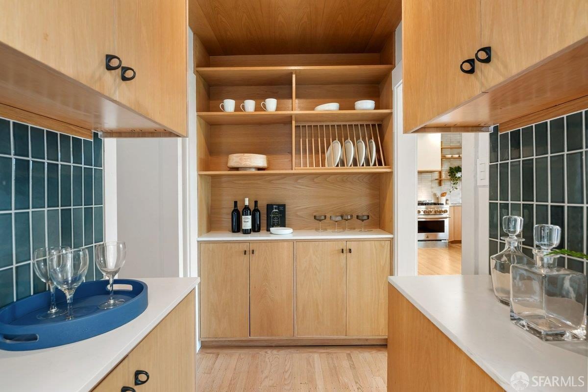 Tenth finished-room view of warm wood island kitchen cabinetry and surrounding surfaces in San Francisco