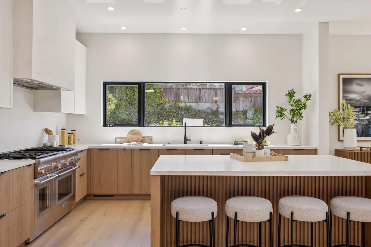 Second finished-room view of light wood kitchen & laundry in tiburon cabinetry and surrounding surfaces