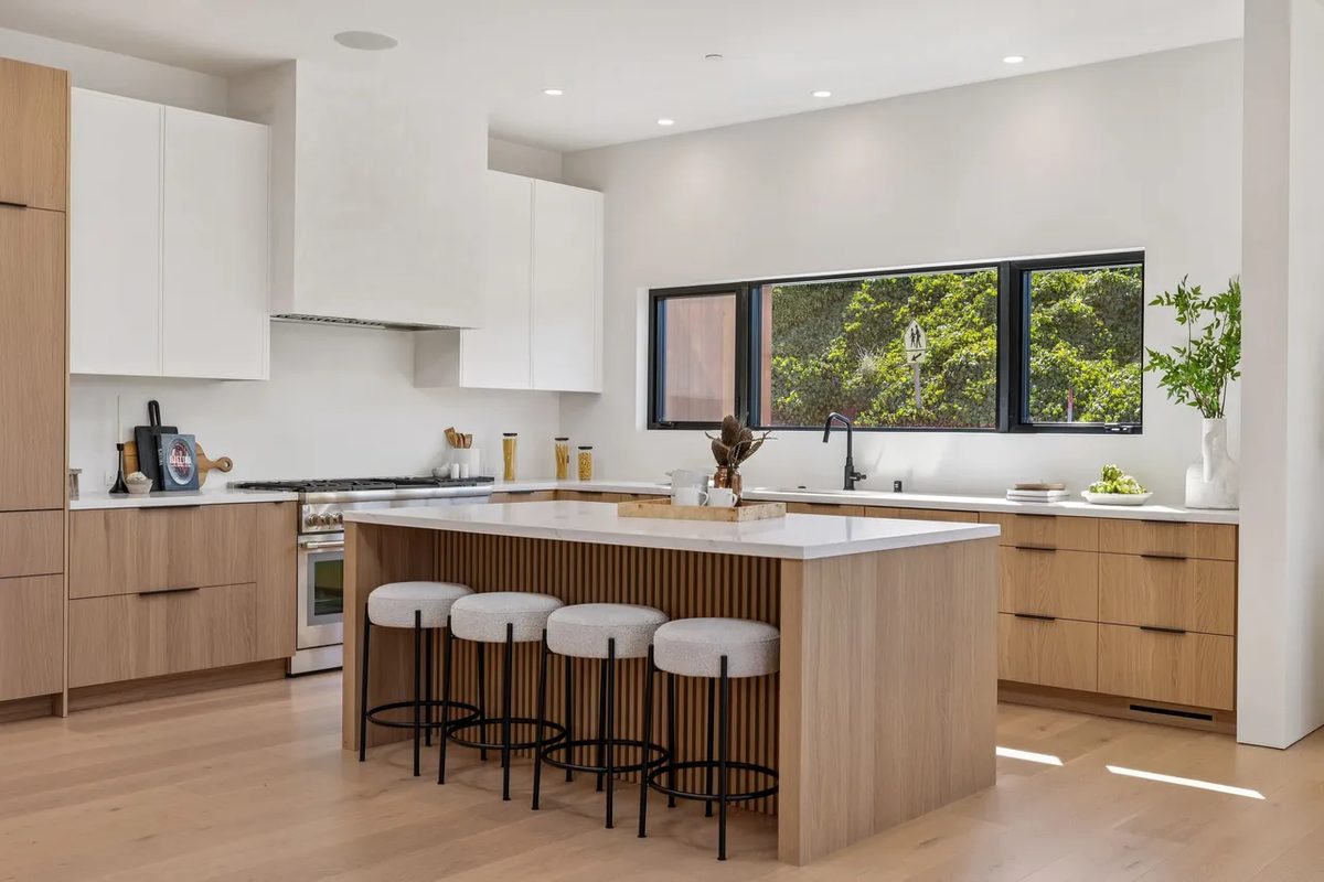 Third finished-room view of light wood kitchen & laundry in tiburon cabinetry and surrounding surfaces