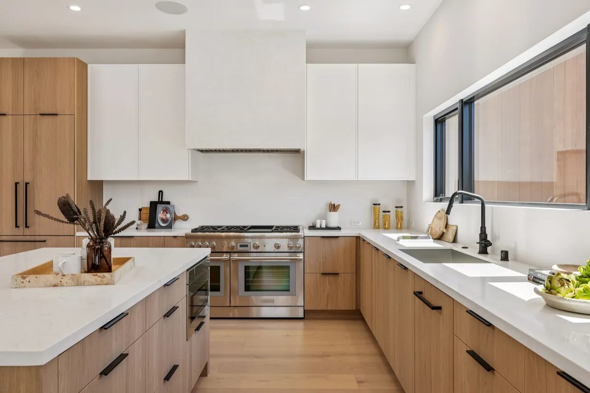 Fourth finished-room view of light wood kitchen & laundry in tiburon cabinetry and surrounding surfaces