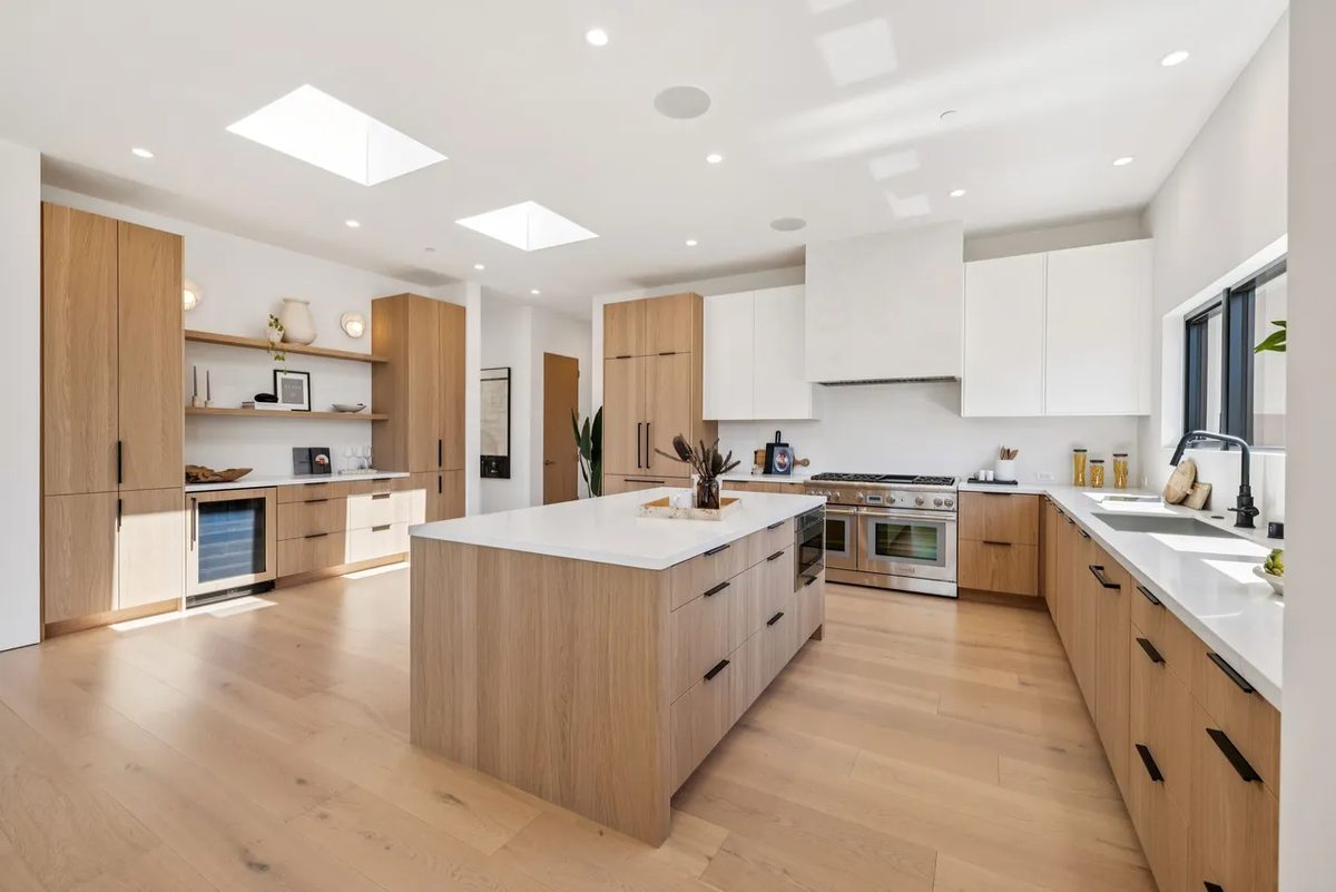 Fifth finished-room view of light wood kitchen & laundry in tiburon cabinetry and surrounding surfaces