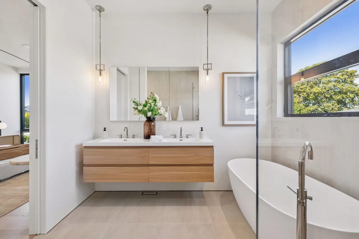 Seventh finished-room view of light wood kitchen & laundry in tiburon cabinetry and surrounding surfaces