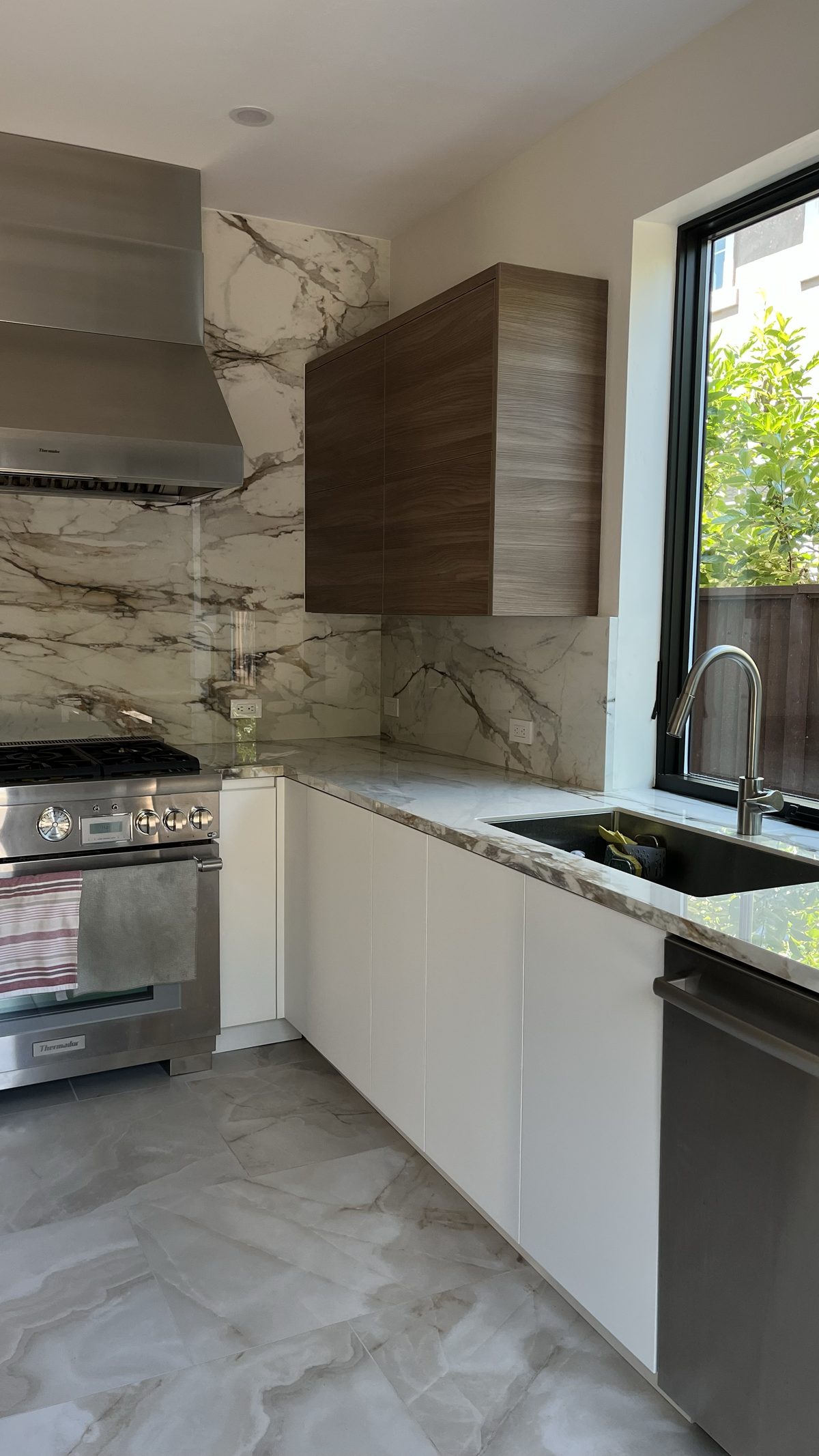 Third finished-room view of two-tone kitchen & built-ins cabinetry and surrounding surfaces
