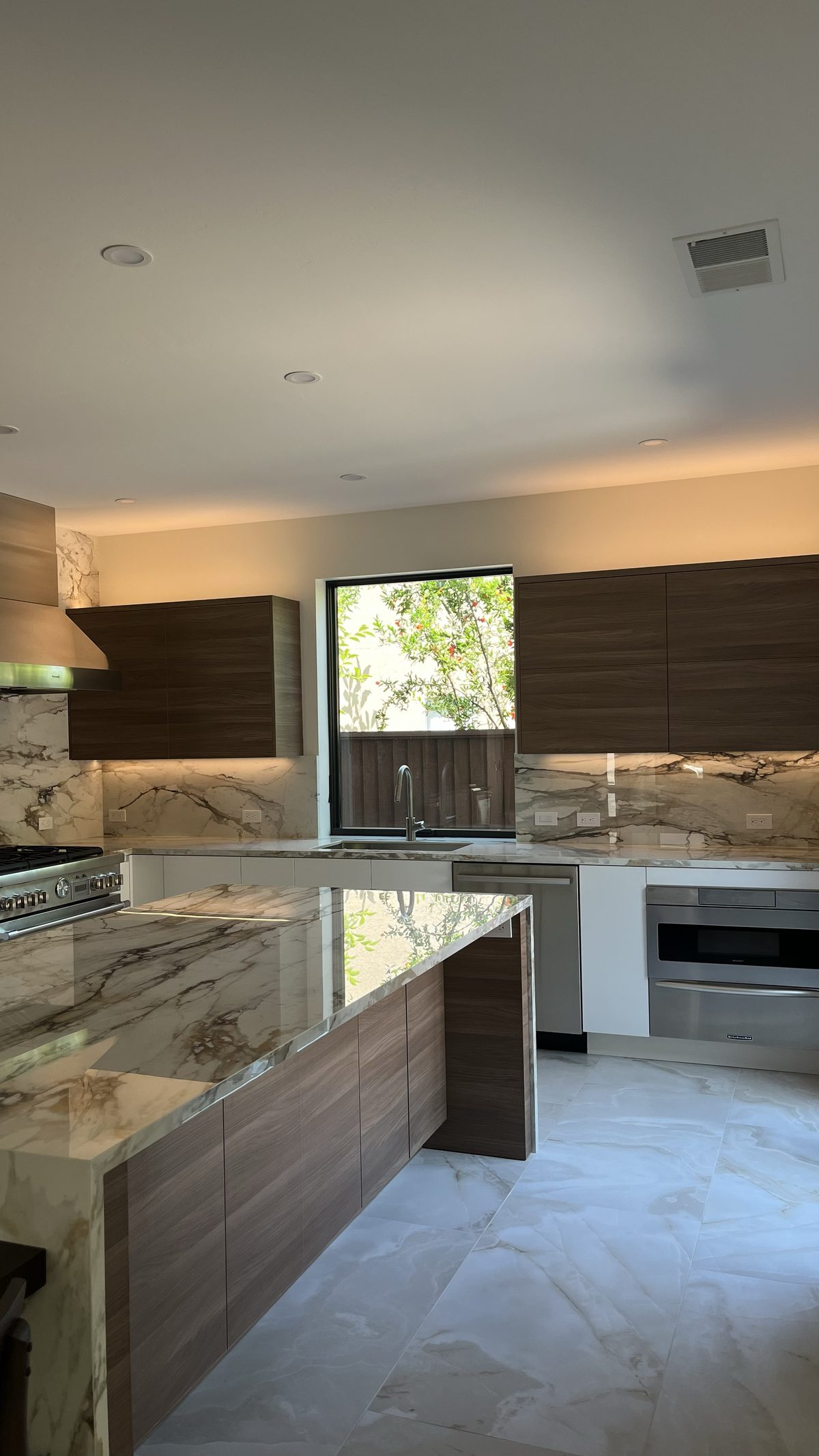 Seventh finished-room view of two-tone kitchen & built-ins cabinetry and surrounding surfaces