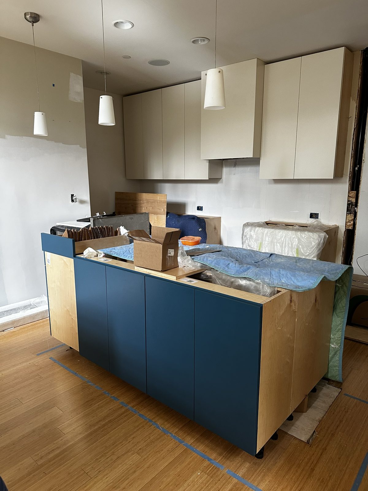 Primary finished-room view of two-tone kitchen cabinetry and surrounding surfaces