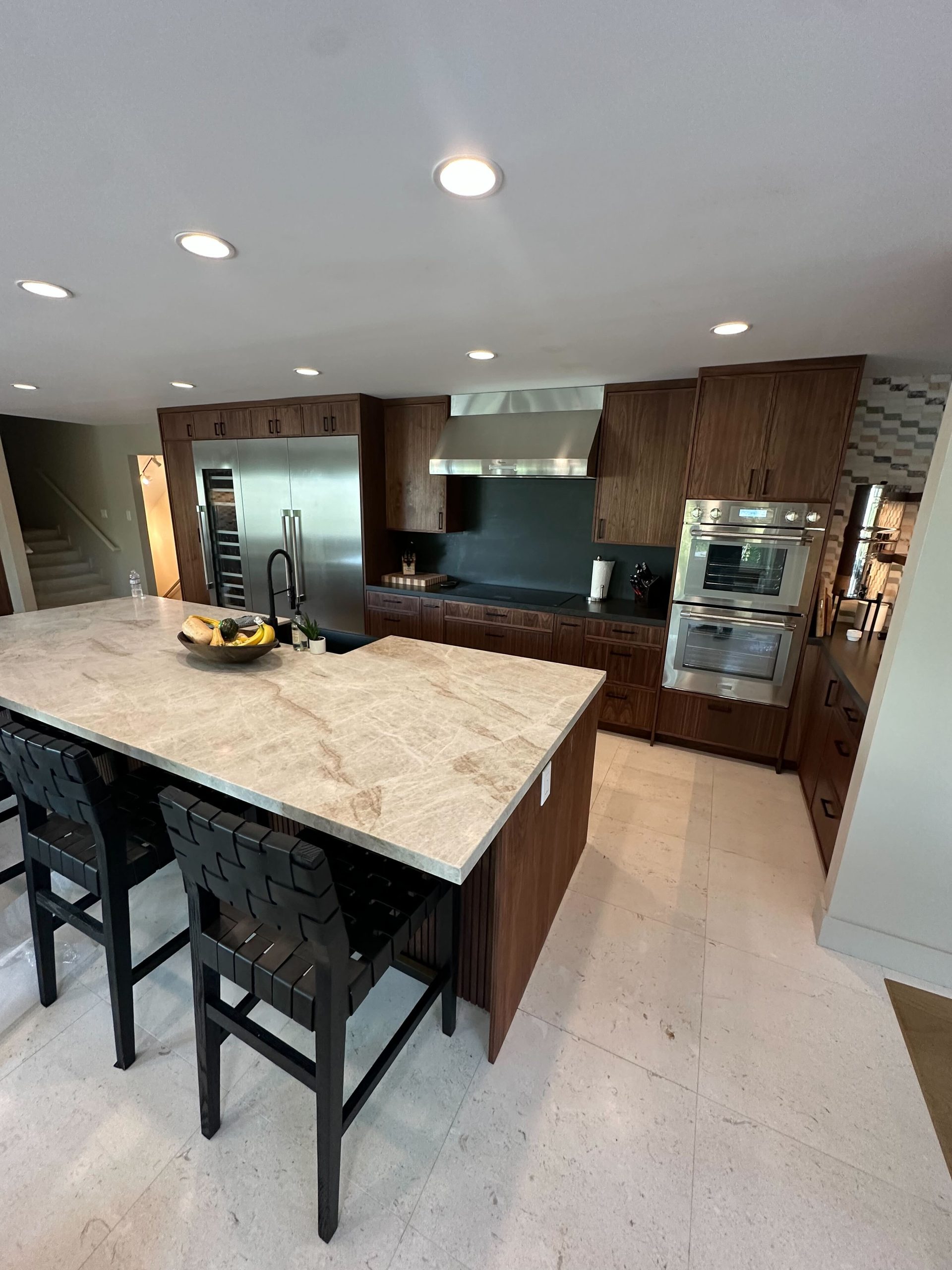 Primary finished-room view of walnut kitchen, bar & home office cabinetry and surrounding surfaces