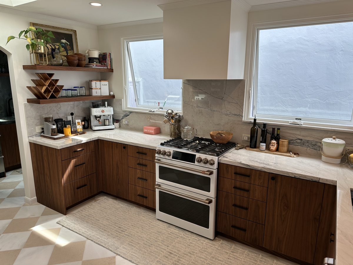 Third finished-room view of walnut kitchen & tall storage cabinetry and surrounding surfaces