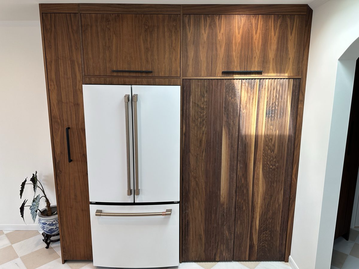 Fourth finished-room view of walnut kitchen & tall storage cabinetry and surrounding surfaces