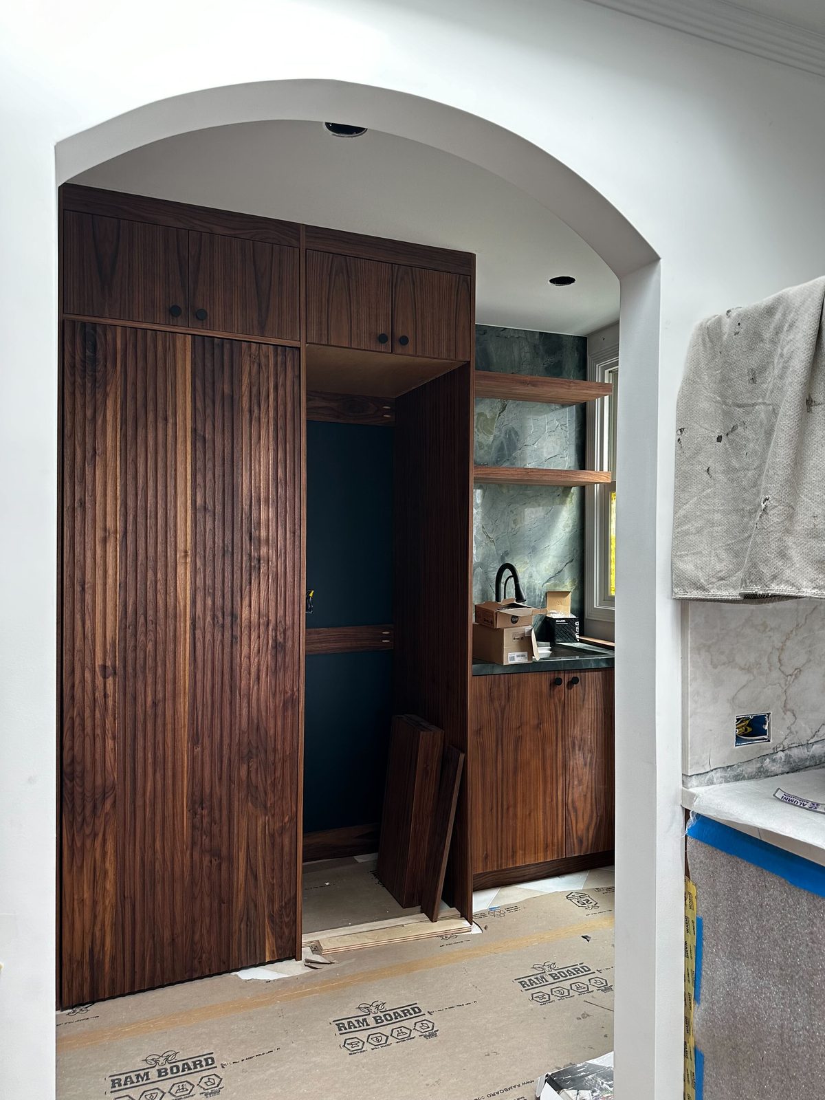 Sixth finished-room view of walnut kitchen & tall storage cabinetry and surrounding surfaces
