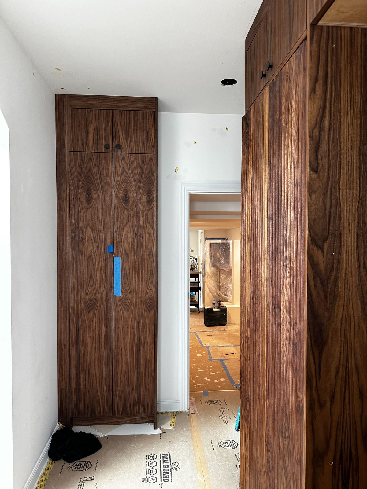 Seventh finished-room view of walnut kitchen & tall storage cabinetry and surrounding surfaces